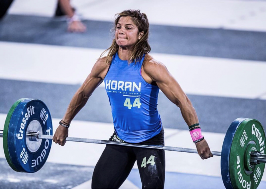 A woman lifting a heavy barbell.