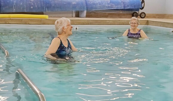 A therapist and patient do arm work in the aquatic therapy pool.