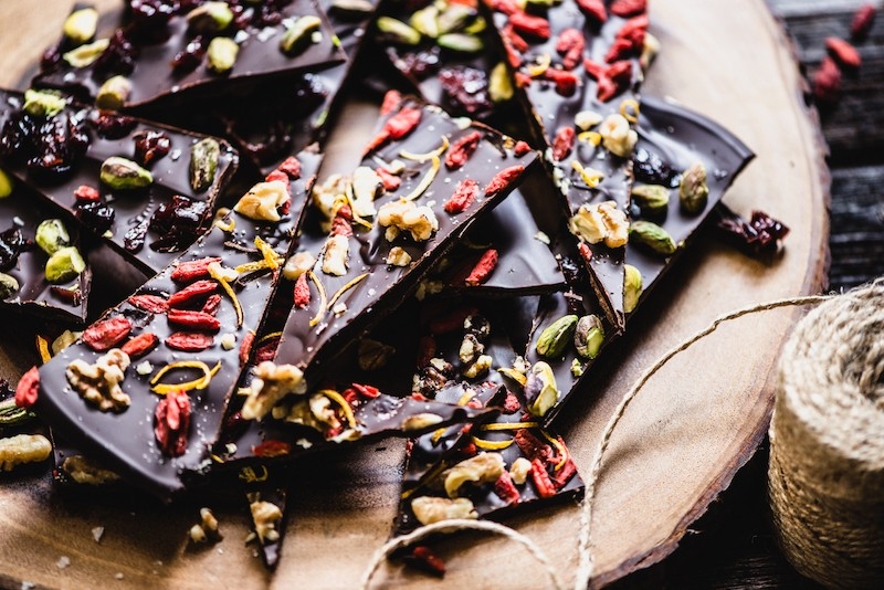 A photo of a few pieces of dark chocolate bark on a platter