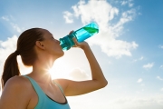 A woman drinks water out of a bottle