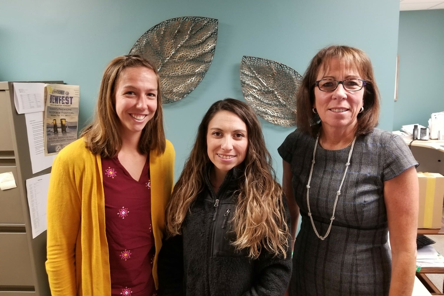 A photo of three physical therapists one of whom is visiting from Chile
