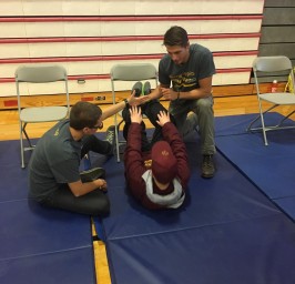 A photo of a young boy doing sit ups.