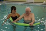 A photo of a physical therapist working with a patient in the PT360 aquatic therapy pool