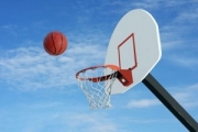 A basketball files towards a basket
