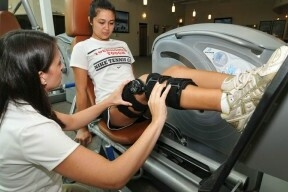 A physical therapist works with a patient to reduce knee pain and increase hip strength