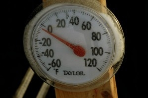 A picture of a dial thermometer reading around zero degrees