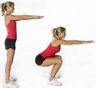 A photo of a woman performing a squat exercise.
