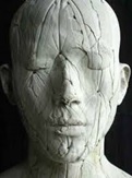 A photo of sculpture of a human head.