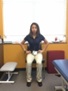 A woman performs seated transverse abdominus exercises.