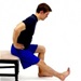A man performs a seated hamstring stretch.